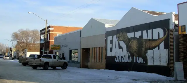 Main Street storefronts with dinosaur mural